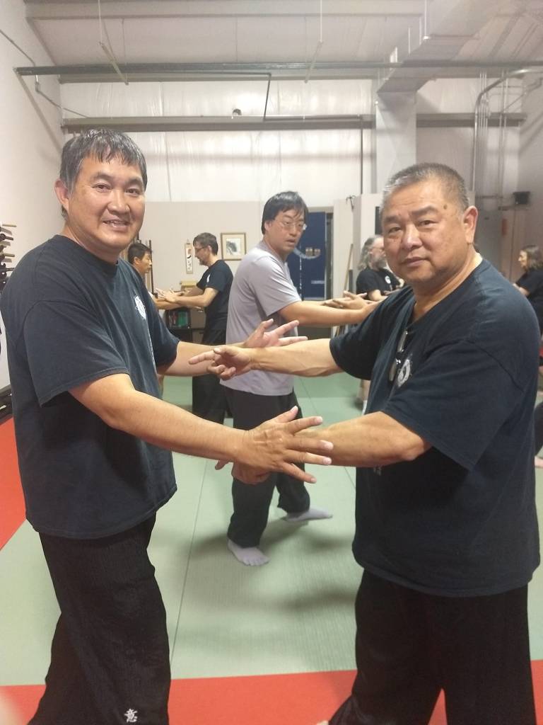 photo of GM Sam Chin & Instructor Henry Lai spinning hands in 2019